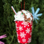 hot cocoa cup ornament with whipped cream and a straw